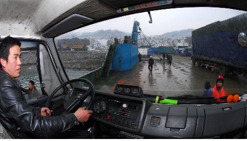 1月21日,一輛從重慶開往湖北武漢的車輛在工作人員的指揮下離開滾裝船上岸。 新華社發(fā)(鄭家裕 攝)