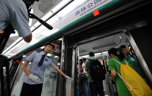 7月19日,地鐵奧運(yùn)支線的乘務(wù)員引導(dǎo)記者進(jìn)入車廂。當(dāng)日上午,在京媒體記者搶先體驗(yàn)即將于下午正式開通的北京地鐵奧運(yùn)支線。北京地鐵奧運(yùn)支線位于北京市南北中軸線下,奧林匹克中心區(qū)內(nèi),全線共設(shè)4座車站,是惟一直接進(jìn)入奧運(yùn)中心區(qū)的地鐵線路。 新華社記者 李文攝