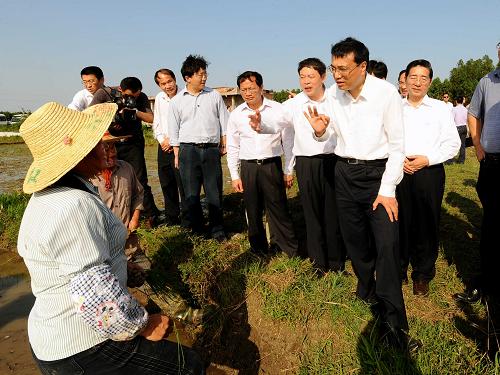 這是4月20日,李克強(qiáng)在來賓市小平陽鎮(zhèn)長(zhǎng)山社區(qū)水泡屯一塊水田旁,向正在耕作的農(nóng)民了解春耕春種情況。 新華社記者 李濤 攝