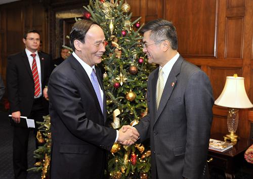 12月14日,在美國(guó)首都華盛頓,中國(guó)國(guó)務(wù)院副總理王岐山(左)與美國(guó)商務(wù)部部長(zhǎng)駱家輝在會(huì)談前握手。新華社記者 張軍 攝