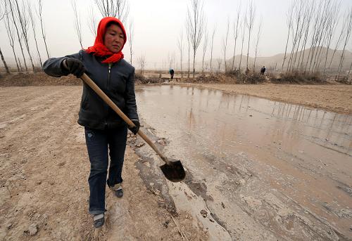 2月18日,蘭州市皋蘭縣西岔鎮(zhèn)峴子村農(nóng)民在澆灌土地。新華社記者 韓傳號(hào) 攝