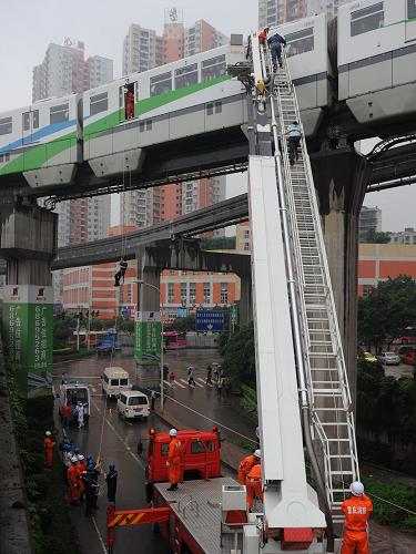 5月26日,救援人員在演練解救輕軌列車被困人員。當(dāng)天,重慶市舉行突發(fā)大面積停電事故應(yīng)急聯(lián)合演練。在演練中,救援人員將因“停電”而困在九龍坡區(qū)輕軌列車內(nèi)的人員通過消防云梯、繩降等方式解救出來。新華社記者 周衡義 攝
