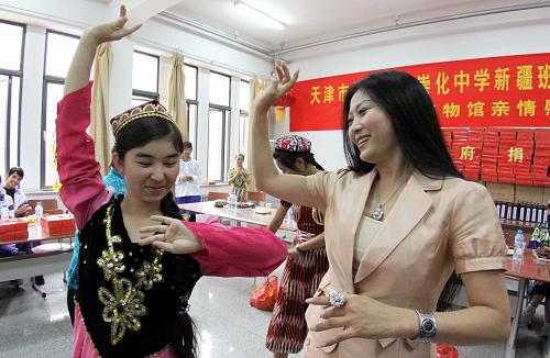 9月29日,天津市愛心企業(yè)代表與崇化中學新疆班的學生一起聯(lián)歡。當日,天津崇化中學500余名新疆班的學生在學校禮堂參加“紅十字博愛傳情 民族團結同樂慶佳節(jié)”主題聯(lián)歡活動。天津市紅十字會及愛心企業(yè)代表向學生們贈送了清真月餅等節(jié)日食品和學習生活用品。學生們共同聯(lián)歡,迎接新中國成立60周年和中秋佳節(jié)的到來。新華社發(fā)(李想 攝)