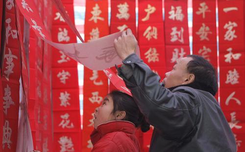 1月25日,陜西省漢中市略陽縣的居民在選購春聯(lián)。當(dāng)日是大年三十,陜西省漢中市略陽縣地震災(zāi)區(qū)的居民忙著選購春聯(lián)、福字等,迎接紅紅火火的新春佳節(jié)。 新華社記者 邢廣利 攝