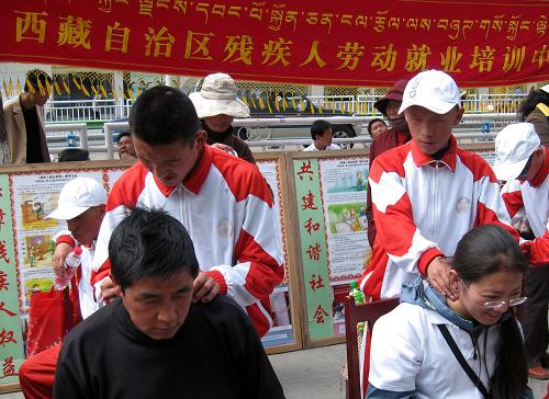 5月17日,拉薩市特殊學(xué)校的孩子在展示自己的培訓(xùn)成果,給行人按摩。新華社記者 覺(jué)果 攝