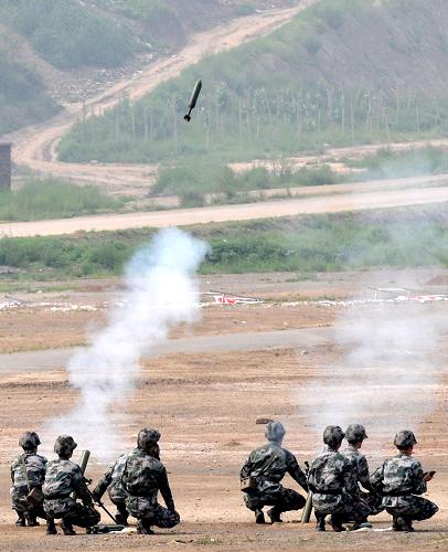 7月30日,在山西省軍區(qū)教導(dǎo)大隊訓(xùn)練場,參演官兵正在進行迫擊炮森林滅火演練。新華社發(fā)(孟晨光 攝)
