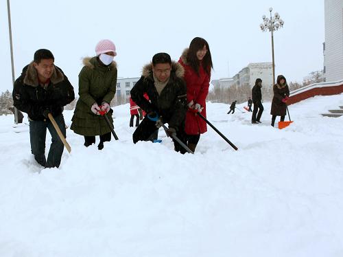 2月5日,富蘊(yùn)縣機(jī)關(guān)干部在街頭清理積雪。新華社發(fā)(丁寧 攝)