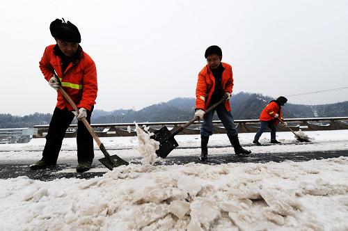 湖南省常(德)吉(首)高速公路上正在開展清理積雪工作的路政工作人員(1月3日攝)。當(dāng)日,湖南省相關(guān)部門積極采取有力措施全力保障高速公路雪后安全暢通。據(jù)悉,從2011年1月1日起,受北方冷空氣擴散南下影響,湖南出現(xiàn)凝凍天氣,省內(nèi)多條高速公路出現(xiàn)了不同程度結(jié)冰現(xiàn)象。目前,湖南省高速公路通行情況比較順暢,當(dāng)?shù)亟痪吐氛块T已經(jīng)全員上路段,采取巡邏、鏟雪、鋪設(shè)麻袋等措施來保障道路的安全通行。新華社記者 龍弘濤 攝
