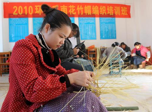 12月2日,廣西環(huán)江縣下南鄉(xiāng)政府在組織毛南族婦女學(xué)習(xí)編織花竹帽工藝。在有30多萬人口的環(huán)江毛南族自治縣,79歲高齡的毛南族老人譚順美是目前花竹帽編織工藝的傳人。目前,當(dāng)?shù)卣诜e極組織開展花竹帽編織培訓(xùn)班,拯救毛南族這一珍貴的“族寶”。花竹帽又稱“頂蓋花”,是毛南族青年的傳情之物,現(xiàn)已被列入我國“非遺”名錄。這種外形類似斗笠的帽子由竹子手工編制而成,造型美觀,但工藝比較復(fù)雜,取材也較為講究。目前,花竹帽的制作流程沒有任何文字記錄或圖片說明,僅憑老工匠在直系或嫡系親屬間口頭傳授和示范。 新華社記者 張愛林 攝