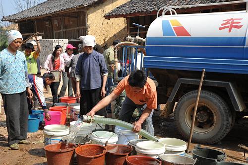 3月2日,廣西靖西縣吞盤鄉(xiāng)必樣村群眾在送水車旁接取生活用水。連日來,面對持續(xù)加劇的旱情,廣西百色市靖西縣抗旱服務隊積極投入到“清水送旱區(qū)”行動中,將一車車清水送到旱區(qū)村屯,確保旱區(qū)群眾基本生活用水。新華社發(fā)(趙京武 攝)