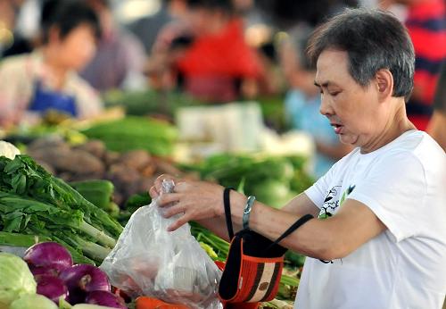 6月14日,市民在??谑幸晦r(nóng)貿(mào)市場購買蔬菜。國家統(tǒng)計局6月14日公布,5月份我國CPI同比上漲5.5%,環(huán)比上漲0.1%。新華社記者 侯建森 攝