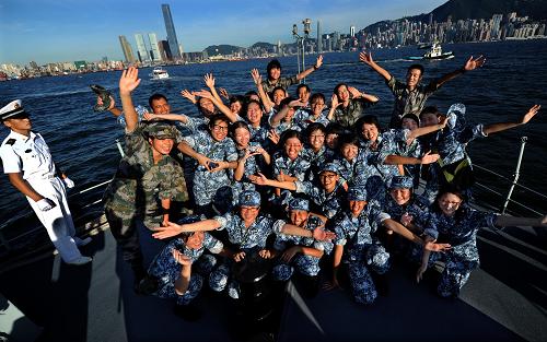 8月14日,大學(xué)生們與駐港部隊(duì)官兵在行進(jìn)中的登陸艇艦首留影。新華社記者 陳曉偉 攝