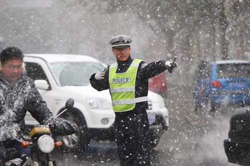 11月2日,交警在煙臺(tái)市街頭頂風(fēng)冒雪指揮交通。新華社發(fā)(申吉忠 攝)