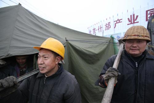 1月26日,幾名建筑工人從北京什邡產(chǎn)業(yè)園建筑工地走過(guò)。新華社記者 汪永基 攝