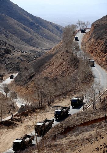 4月7日,進行實戰(zhàn)訓練的車隊在山路間行駛。新華社記者 任軍川 攝