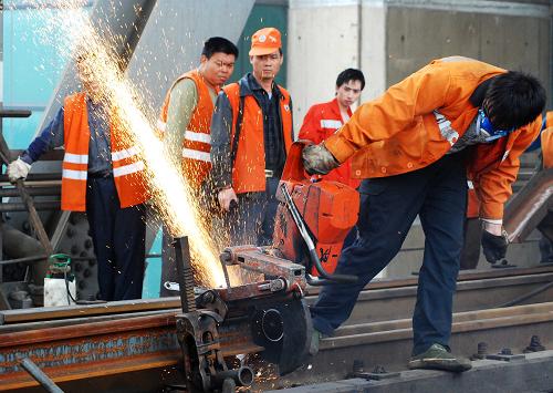 5月20日,南昌鐵路局鷹潭工務(wù)機(jī)械段的工人們在九江長江大橋鐵路橋上更換鋼軌。當(dāng)日,九江長江大橋鐵路橋上行線更換鋼軌工作順利完成。5月10日開始,九江長江大橋鐵路橋自通車后首次進(jìn)行全面更換鋼軌,大橋上、下行線路共計(jì)16公里的鋼軌計(jì)劃6月底全部更換完畢。大橋全面更換鋼軌后,線路質(zhì)量和穩(wěn)定性將全面得到提升。新華社發(fā)(胡國林 攝)