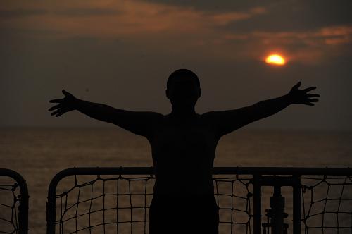 5月30日,一位船員在中國(guó)“海監(jiān)83”船后甲板上“擁抱”夕陽(yáng)下的大海。新華社記者 金良快 劉華攝影報(bào)道