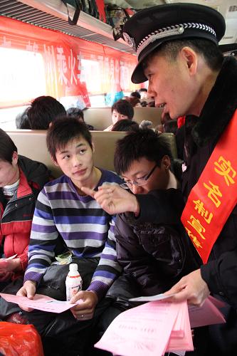 一名乘警正在向乘客宣傳實(shí)名制售票相關(guān)問題。新華社發(fā)(肖勇攝)