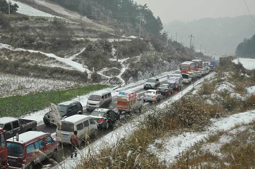 1月17日傍晚,大批車輛在貴州凱里市境內(nèi)308省道凝凍路段排起長龍。 當日,貴州省黔東南州凱里市迎來新一輪低溫降雪和凍雨天氣,至下午4時,境內(nèi)308省道278公里至285公里大部分路段路面出現(xiàn)嚴重結(jié)冰,2000多輛汽車被堵在長達6公里的路段。凱里路政除冰突擊隊員趕赴現(xiàn)場,撒鹽化冰,于當晚10點疏通所有滯留車輛。新華社發(fā)(陳沛亮 攝)