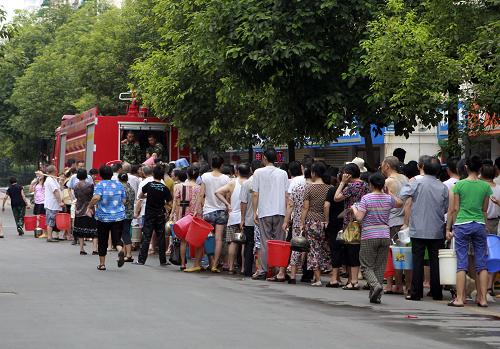 7月27日,四川綿陽市民在街頭排隊打水。綿陽市政府26日發(fā)布通告,阿壩州松潘縣一電解錳廠21日受暴雨影響,礦渣流入涪江,綿陽市26日監(jiān)測出涪江江油、綿陽段水質(zhì)錳和氨氮超標(biāo),提醒市民不要飲用自來水。目前,綿陽市已采取集中送水、調(diào)度成品水等方式,解決飲用水問題。新華社發(fā)