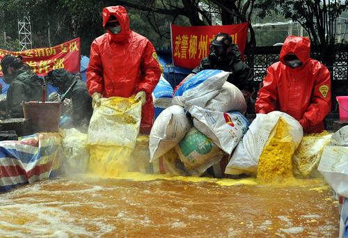 在廣西柳州市柳城縣鳳山鎮(zhèn)糯米灘水電站,消防人員在向處理池投放物料稀釋中和遭遇鎘污染的河水(2012年1月29日攝)。新華社記者 陸波岸 攝