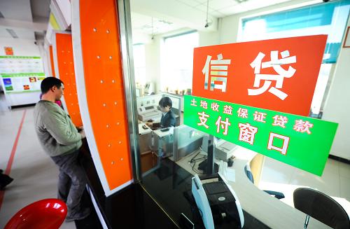 1月9日,梨樹縣靠上屯村民牛躍軍在吉林省農(nóng)村信用社十家堡信用社辦理土地收益保證貸款業(yè)務(wù)。新華社記者 許暢 攝
