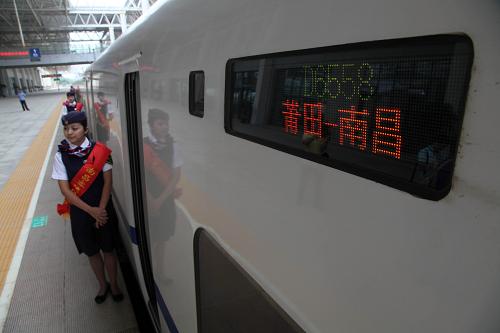 9月26日,在福建莆田火車站,乘務員在一列從莆田開往南昌的動車旁迎接旅客。新華社發(fā)(林劍冰 攝)
