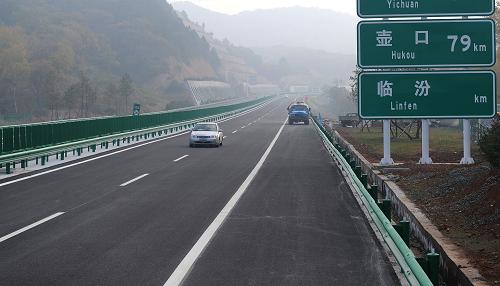 10月18日,施工車行駛在即將通車的青(島)蘭(州)高速公路上。投資近139億元的青島至蘭州高速公路陜西段將于11月初全線建成通車,陜西段全長(zhǎng)192公里,是自東向西橫貫陜西全境的一條全立交、全封閉四車道高速公路,屆時(shí)人們由西安去黃河壺口瀑布旅游的路程將全部變?yōu)楦咚俟罚瑫r(shí)間也由原先5個(gè)半小時(shí)縮短至不到4小時(shí)。新華社記者 陶明 攝