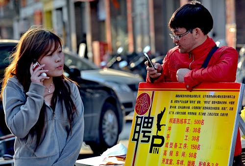 在福建晉江市一招工市場(chǎng), 兩名招工人員在門庭冷落的攤位前打電話和玩手機(jī)(2月22日攝)。 元宵節(jié)過(guò)后,務(wù)工人員紛紛走出家門尋找工作,各地用工企業(yè)也隨之進(jìn)入招工高潮。相比之下而言,工資待遇較高、勞動(dòng)環(huán)境較好、企業(yè)信譽(yù)度較高的企業(yè)招工相對(duì)容易,這些企業(yè)節(jié)后生產(chǎn)開工率達(dá)到60%―70%以上;而一些工資待遇較低、勞動(dòng)環(huán)境較差、企業(yè)信譽(yù)度不高的企業(yè)招工卻難上加難,目前的生產(chǎn)開工率只有50%,甚至更低。 新華社記者 張國(guó)俊 攝