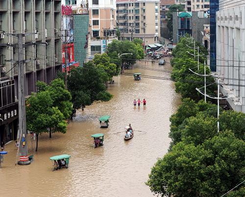 浙江蘭溪遭遇56年來最大洪峰 6月20日,市民在市區(qū)涉水出行,最深處已達1.5米左右。 6月19日晚至20日晨,蘭江流域再遇強降雨。6月20日8時,錢塘江干流洪峰到達蘭溪,洪峰水位33.75米,為1955年以來最高水位。省防指決定啟動錢塘江干流防御特大型洪水方案,蘭溪市委、市政府發(fā)出緊急動員令,蘭溪市已進入緊急防汛期。 新華社記者 徐昱 攝