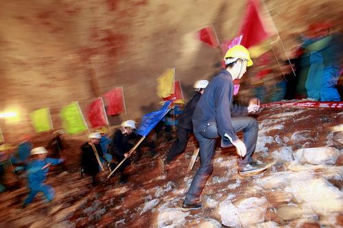 云桂鐵路石林隧道順利貫通 12月10日,中鐵一局的施工人員在石林隧道貫通儀式上歡慶。 當日,云桂鐵路線上的石林隧道在云南石林順利貫通。云桂鐵路連接云南昆明和廣西南寧,石林隧道進口位于云南省彌勒縣,出口在云南省石林縣,隧道設計為單洞雙線,全長18.2公里,造價約13億元,整個隧道掘進累加長度約40千米,工程浩大。自2010年8月開工以來,經過中鐵一局建設者三年多的艱苦奮斗,戰(zhàn)勝了喀斯特地質隧道施工的艱難險阻,提前半年使全隧道安全貫通。 新華社記者李明放攝