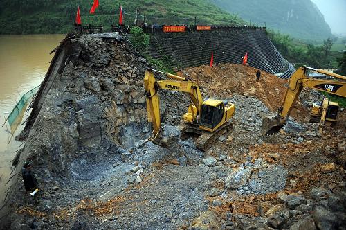 7月5日,武警水電一總隊的施工機械正在切割卡馬水庫右側(cè)大壩。 新華社記者 張愛林 攝