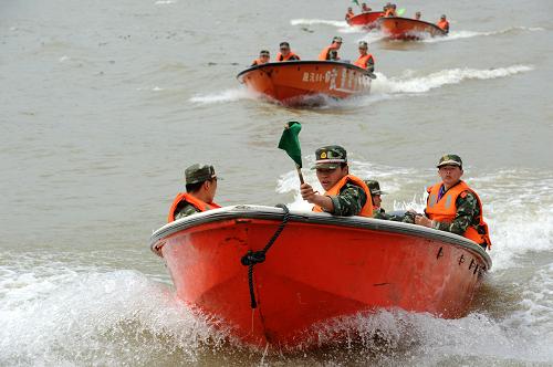 4月19日,武警福建總隊(duì)官兵在福州閩江西河段水域進(jìn)行舟艇水上編隊(duì)航行演練。當(dāng)日,為檢驗(yàn)訓(xùn)練成果、強(qiáng)化部隊(duì)搶險(xiǎn)救災(zāi)組織指揮能力,武警福建總隊(duì)在福州閩江西河段水域舉行以舟艇水上編隊(duì)航行、轉(zhuǎn)移人員物資、搶救落水群眾、緊急排險(xiǎn)等為主要內(nèi)容的大規(guī)模防汛抗洪演練,為隨時(shí)應(yīng)對汛期可能發(fā)生的各類災(zāi)害事故做好準(zhǔn)備。當(dāng)前,福建省已進(jìn)入主汛期,針對今年福建省臺風(fēng)偏多,且雨季期間閩江流域上游部分支流可能發(fā)生較大洪水的情況,擔(dān)負(fù)著全省范圍內(nèi)搶險(xiǎn)救災(zāi)增援任務(wù)的武警福建總隊(duì)從4月6日開始,在全省范圍內(nèi)組織近3000名應(yīng)急救援官兵和160艘舟艇,進(jìn)行了為期半個(gè)月的水上救援訓(xùn)練。新華社發(fā)(李濤 攝)
