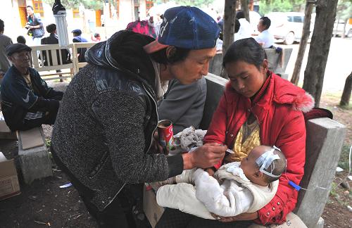 6月25日,云南省寧蒗彝族自治縣永寧鄉(xiāng)的一名受傷兒童在吃飯。云南、四川交界5.7級地震發(fā)生已造成造成兩省7.1萬人受災(zāi),國家減災(zāi)委、民政部緊急啟動國家4級救災(zāi)應(yīng)急響應(yīng)。目前,地震災(zāi)區(qū)各項救援工作已全面展開,云南省緊急下?lián)芰?500萬應(yīng)急資金,公安、消防、解放軍及醫(yī)療隊紛紛趕赴災(zāi)區(qū),各級民政部門及紅十字會安排的數(shù)千件棉衣、棉被及大批帳篷等救災(zāi)物資已經(jīng)送達災(zāi)區(qū)。