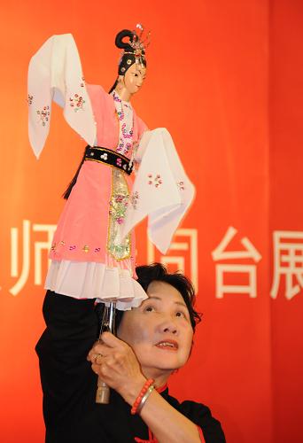 6月10日,在北京中華世紀壇當代藝術中心,國家級非物質(zhì)文化遺產(chǎn)項目代表性傳承人李伯芬在表演木偶戲《番婆弄》。新華社發(fā)(王振攝)