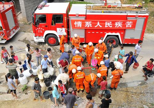 9月3日,貴州興義市消防官兵用3輛大噸位水罐消防車為興義市敬南鎮(zhèn)海子村群眾送飲用水。 。 自今年5月以來,貴州省黔西南布依族苗族自治州出現(xiàn)特重旱情,黔西南州消防支隊積極開展抗旱保民生工作,派出消防官兵深入重旱區(qū)調(diào)研了解旱情,幫助旱區(qū)群眾尋找天然水源,用消防車為旱區(qū)群眾送去急需的生產(chǎn)生活用水。 新華社發(fā)(劉永松 攝)