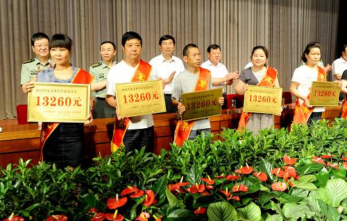 7月25日,義務(wù)兵家庭代表在優(yōu)待金發(fā)放儀式上。 當(dāng)日,鄭州市為2011、2012年度應(yīng)征入伍的義務(wù)兵家庭舉行優(yōu)待金發(fā)放儀式,共有8126戶義務(wù)兵家庭收到優(yōu)待金,發(fā)放金額累計達(dá)1.078億元。鄭州市自2012年起按照“城鄉(xiāng)一體、同役同酬”的原則,建立義務(wù)兵最低優(yōu)待金制度,優(yōu)待金發(fā)放標(biāo)準(zhǔn)不低于全市上年度農(nóng)民人均純收入的1.2倍。 新華社記者 朱祥攝