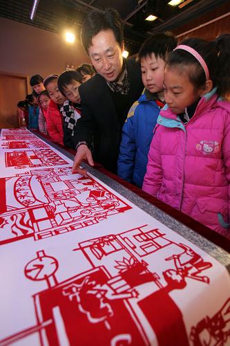 12月22日,小學(xué)生們在天津曹禺故居紀念館參觀傳統(tǒng)剪紙作品。新華社發(fā)(劉東岳 攝)