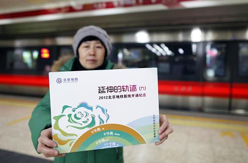12月30日,一名女士在展示購(gòu)買(mǎi)的北京地鐵新線(xiàn)開(kāi)通紀(jì)念票冊(cè)。當(dāng)日,北京地鐵新線(xiàn)開(kāi)通紀(jì)念票冊(cè)在北京發(fā)行。該紀(jì)念票冊(cè)共包括兩張開(kāi)通紀(jì)念車(chē)票和四枚開(kāi)通紀(jì)念封。兩張車(chē)票以6號(hào)線(xiàn)的新型列車(chē)和北海白塔為主題設(shè)計(jì);紀(jì)念封四枚以6號(hào)線(xiàn)一期、8號(hào)線(xiàn)二期南段、9號(hào)線(xiàn)北段、10號(hào)線(xiàn)二期四條新線(xiàn)各具特色的車(chē)站內(nèi)景觀(guān)為主題設(shè)計(jì),四枚紀(jì)念封上分別貼有新線(xiàn)列車(chē)主題個(gè)性化郵票一枚,個(gè)性化郵票主圖為“歲歲平安”,寓意北京地鐵年年安全暢行。新華社發(fā)(楊樂(lè) 攝)