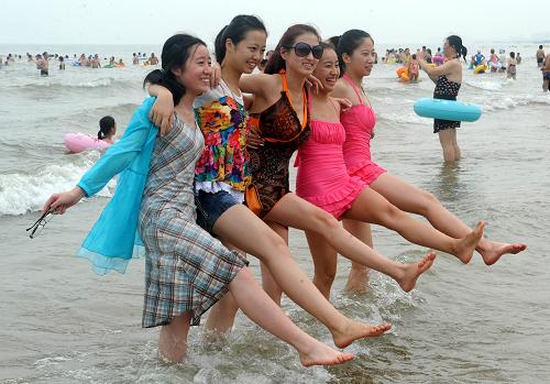7月28日,游客在青島石老人海水浴場游玩,海灘上未見到滸苔蹤跡。新華社記者 李紫恒 攝