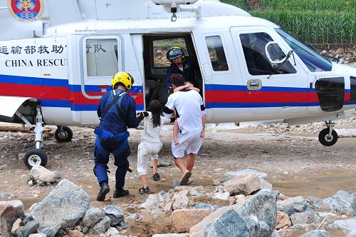 8月18日,交通運輸部北海第一救助飛行隊的救援人員在救助遼寧省撫順市清原縣被洪水圍困的群眾。受持續(xù)強降雨影響,遼寧省撫順市清原縣受災嚴重。8月17日至18日,交通運輸部先后派出駐山東蓬萊和遼寧大連的北海第一救助飛行隊兩架專業(yè)救助直升機馳援災區(qū)。截至目前,救助飛行隊已飛行8架次,在清原縣災區(qū)投放物資400多公斤,緊急轉(zhuǎn)運被困群眾和傷員28人,其中包括4名重傷人員和3名孕婦。新華社發(fā)(馮小熒 攝)