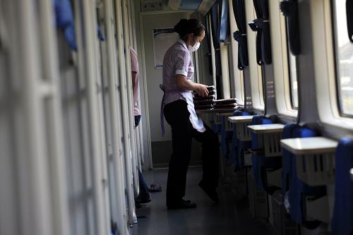 9月19日,在K1271次杭州開往成都的列車上,餐車服務(wù)員在為乘客送盒飯。當(dāng)日是中秋節(jié),一些特殊崗位的工作人員無法和家人團(tuán)圓,在節(jié)日里堅守工作崗位。新華社發(fā)(張廣玉 攝)