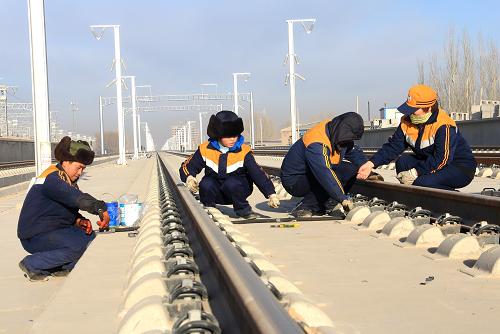 12月12日,在蘭新鐵路第二雙線玉門站內(nèi),蘭州鐵路局嘉峪關(guān)電務(wù)段職工正在進(jìn)行股道信號(hào)設(shè)備架裝施工。新華社發(fā)(周東山 攝)