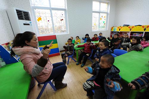 六盤水市水城縣發(fā)耳鎮(zhèn)中心幼兒園的老師在帶小朋友們做游戲(12月26日攝)。新華社記者 陶亮 攝