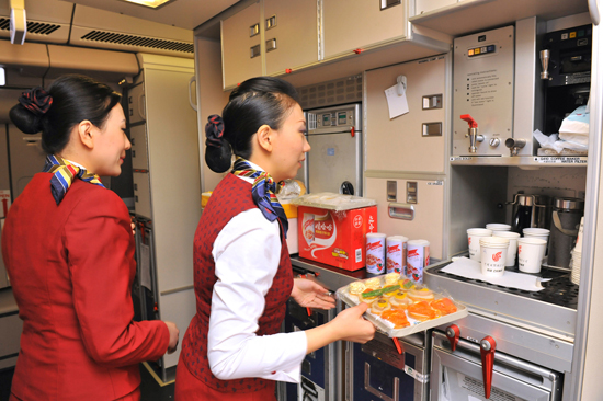2月23日,在負(fù)責(zé)撤回利比亞中方人員的首架中國(guó)國(guó)航A330包機(jī)上,空中乘務(wù)員正在準(zhǔn)備餐食。新華社發(fā)(王澤民 攝)