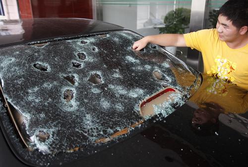 6月25日,河南嵩縣一輛汽車的玻璃被冰雹砸壞。新華社發(fā)(張曉理 攝)