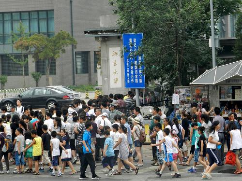 7月17日,在北京大學(xué)東門,游客排隊進(jìn)門參觀。新華社發(fā)(王振 攝)