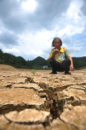 8月2日,在貴州石阡縣石固鄉(xiāng)南橋村,一位村民蹲在干涸的水庫(kù)庫(kù)底。由于高溫天氣的持續(xù),貴州銅仁地區(qū)石阡縣發(fā)生了自1959年有氣象記錄以來(lái)最嚴(yán)重的旱情,目前全縣范圍內(nèi)有90%以上的鄉(xiāng)(鎮(zhèn))嚴(yán)重缺水,14.6萬(wàn)人和5.1萬(wàn)頭大牲畜飲水困難,85%的田地干枯缺水并部分開(kāi)裂,1.6萬(wàn)公頃農(nóng)作物受災(zāi),直接經(jīng)濟(jì)損失達(dá)1.1億元。目前,石阡縣旱情仍在持續(xù),而且,未來(lái)兩天貴州大部分地區(qū)仍將維持高溫晴熱少雨天氣。貴州省防汛抗旱指揮部已于8月1日將干旱災(zāi)害Ⅳ級(jí)應(yīng)急響應(yīng)提升為Ⅲ級(jí)應(yīng)急響應(yīng)。新華社記者 歐東衢 攝