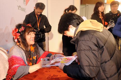 2月1日,在臺(tái)北書(shū)展現(xiàn)場(chǎng),日本漫畫(huà)作者五十嵐優(yōu)美子(左)為粉絲簽名。新華社發(fā)(吳景騰 攝)