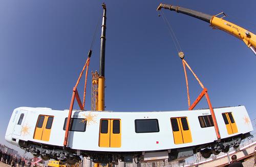 10月15日,大型吊車(chē)在哈爾濱市地鐵太平橋車(chē)輛基地將耐高寒地鐵車(chē)廂吊裝入軌。新華社發(fā)(王忠?guī)r 攝)